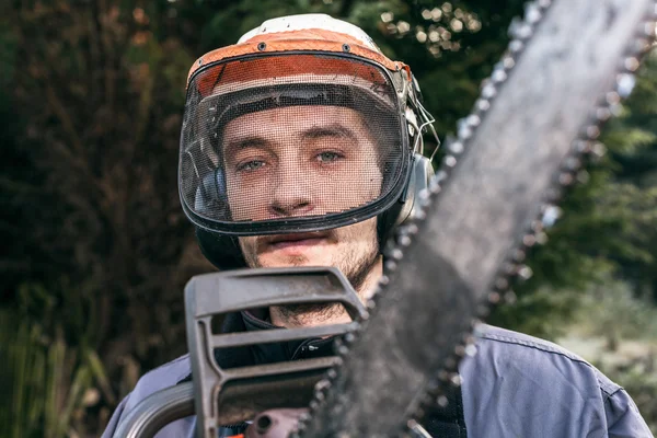 Professional gardener with chainsaw — Stock Photo, Image