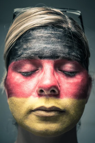 Woman with flag of Germany on face and closed eyes — Stock Photo, Image