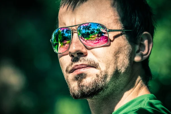 Man in sunglasses with colourful reflection — Stock Photo, Image