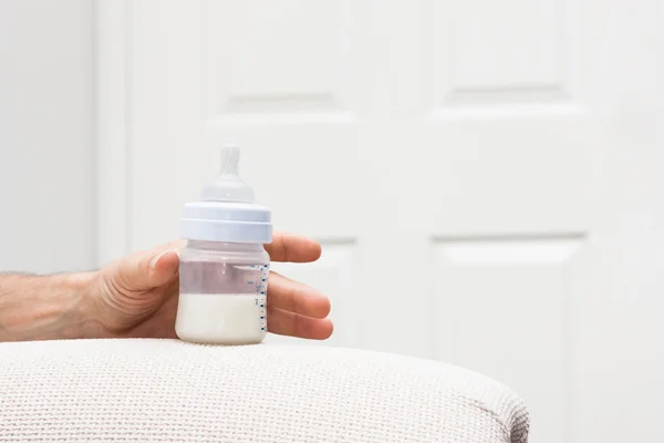 Male hand with baby bottle — Stock Photo, Image