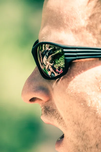Detail of man face in sport sunglasses