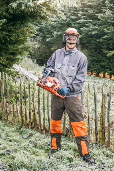 Professional gardener with chainsaw — Stock Photo, Image