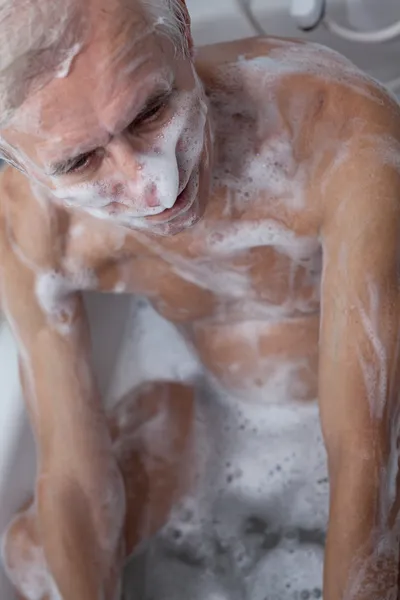 Senior man bathing — Stock Photo, Image