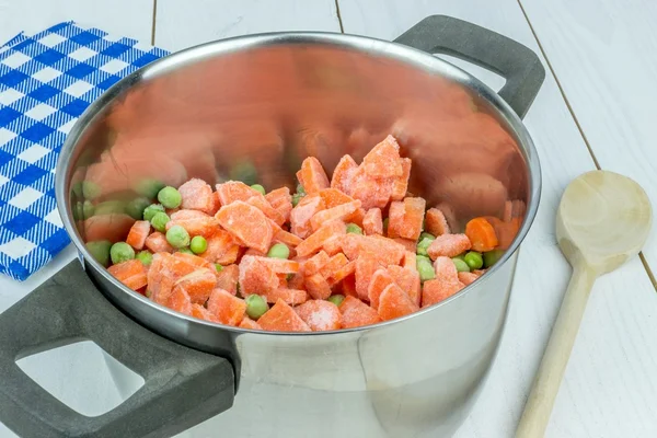 A pot with frozen peas and carrot — Stock Photo, Image