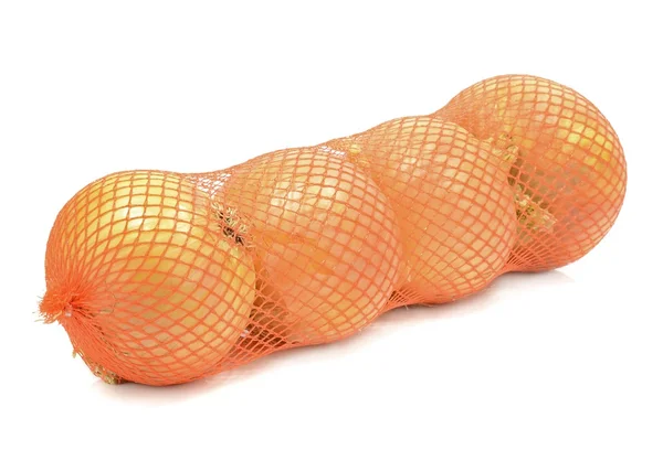 A plastic net bag of onions — Stock Photo, Image