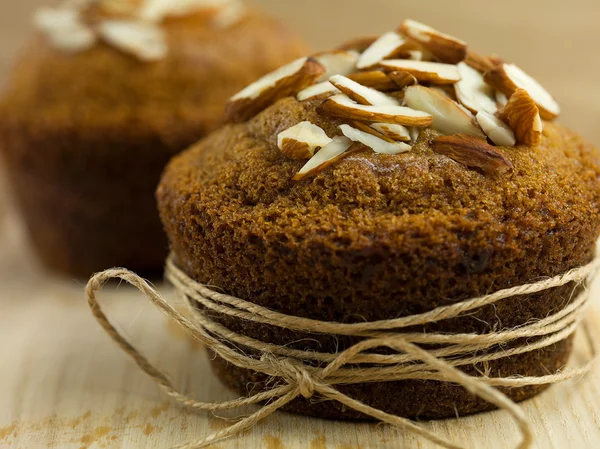 Almond muffin wrapped up as a gift — Stock Photo, Image