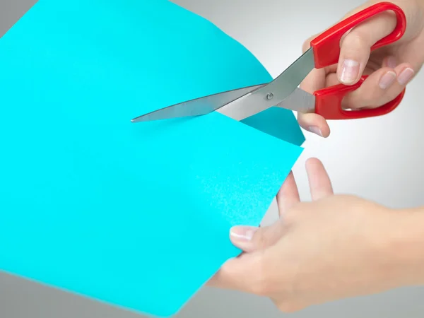 Hands cutting a paper with scissors — Stock Photo, Image