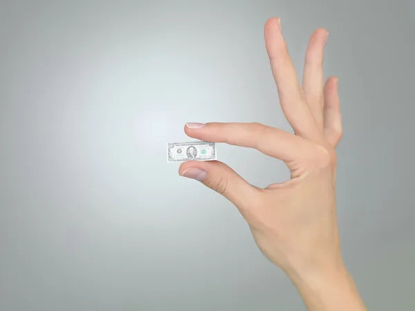 Hand with tiny dollar bill — Stock Photo, Image