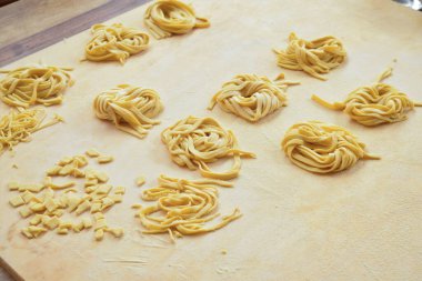 Ev yapımı yumurta makarnası ahşap bir pasta tahtasında.