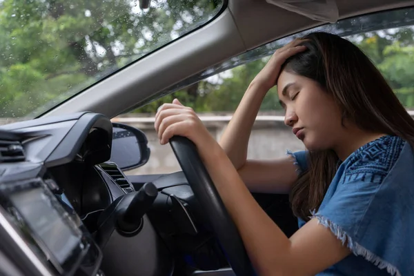 Stressed woman drive car feeling sad and angry. Asian girl tired, fatigue on car. Driver tired drows drink dont drive concept. Sleepy and drunk female hangover. Illegal law driver license.