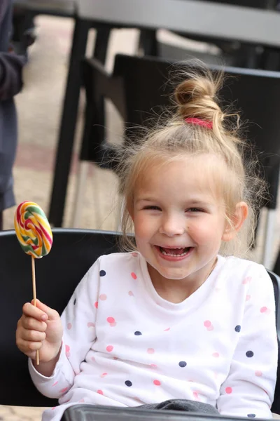 Portret Lachend Klein Meisje Dat Een Snoepje Eet — Stockfoto