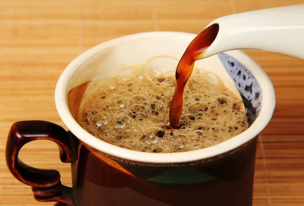 Caffè dalla pentola viene versato nella tazza . — Foto Stock