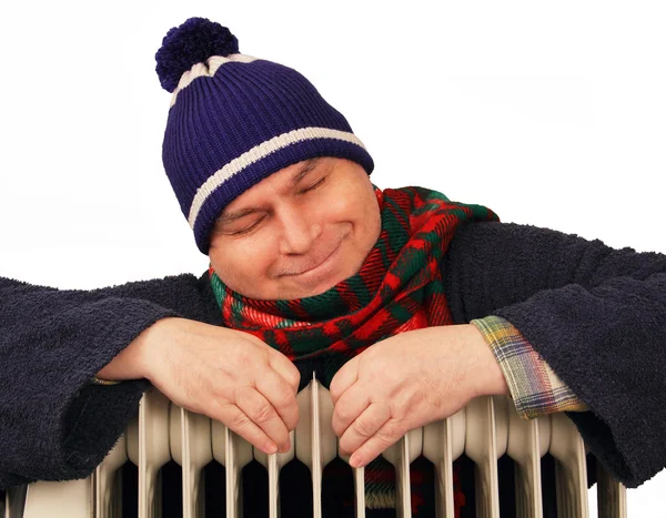 Man basking in the heater. — Stock Photo, Image