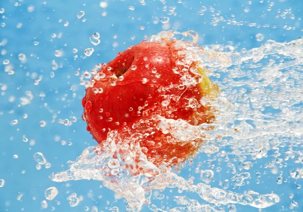 Apple in a jet of water. — Stock Photo, Image