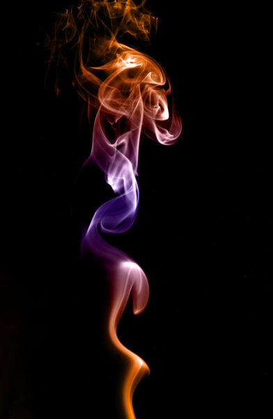 Clubs and tendrils of smoke of different colors isolated on a black background.