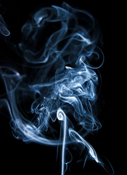 Jet, monochrome clubs and curls of smoke, a photo on a dark background.