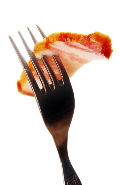 A slice of ham on a steel fork. — Stock Photo, Image