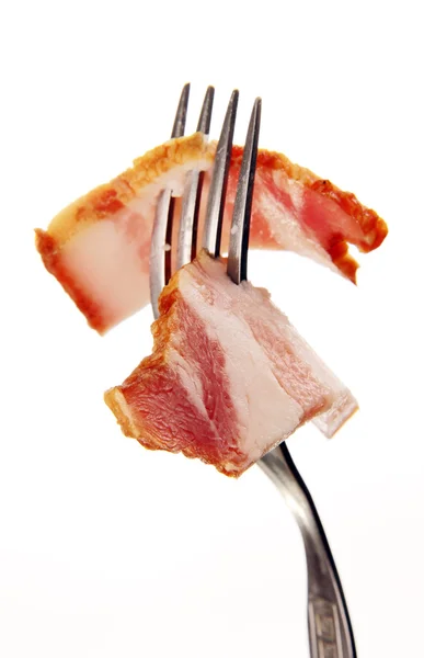 A slice of ham on a steel fork. — Stock Photo, Image