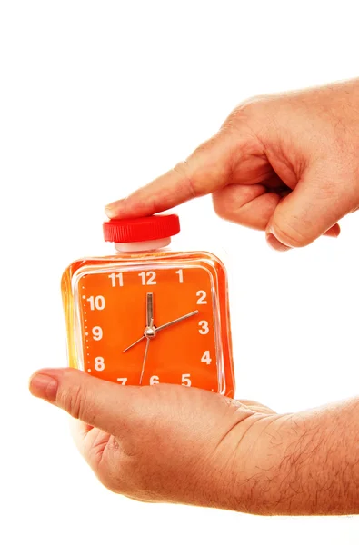 Oranje wekker in een hand op een witte achtergrond. — Stockfoto