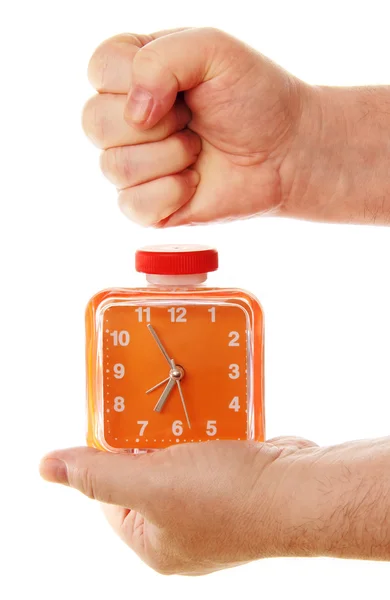 Orange alarm clock in a hand on a white background. Royalty Free Stock Photos