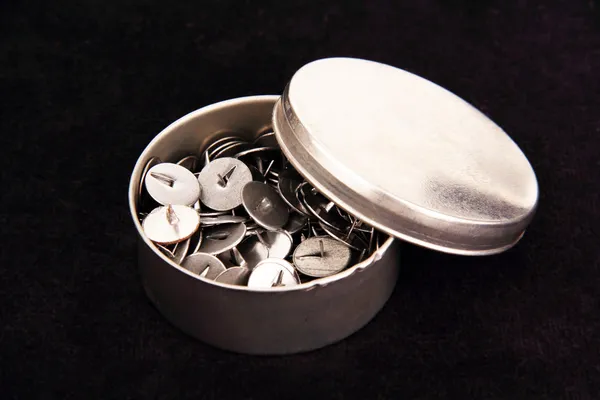 Thumbtacks in a metal box. — Stock Photo, Image