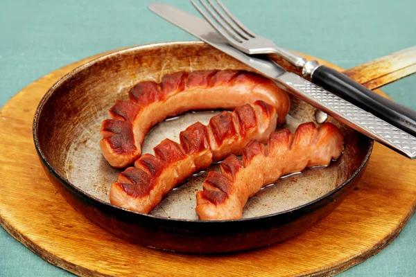 Fried sausage in a skillet. — Stock Photo, Image