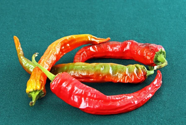 Four red hot peppers. — Stock Photo, Image