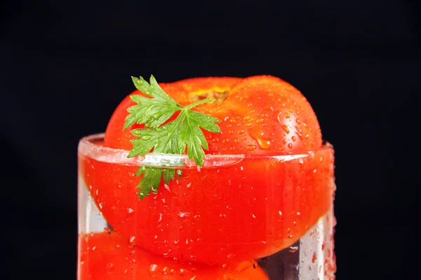 Tomat i ett kärl med vatten. — Stockfoto