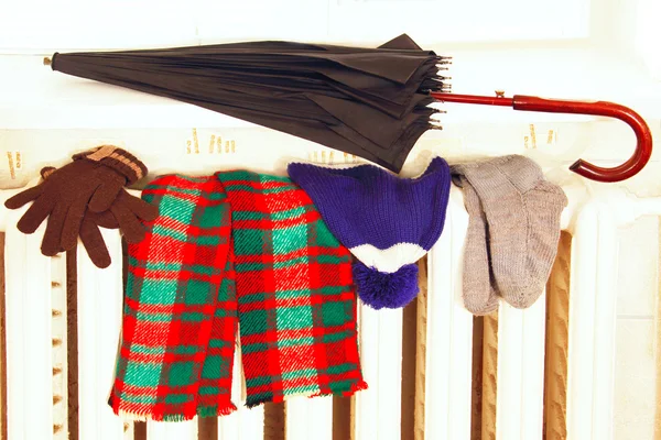 Winter clothes on a radiator. — Stock Photo, Image