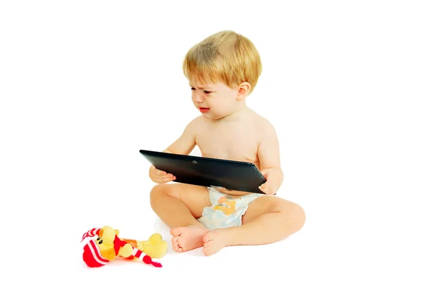Kleines Kind auf dem Tablet. Stockbild