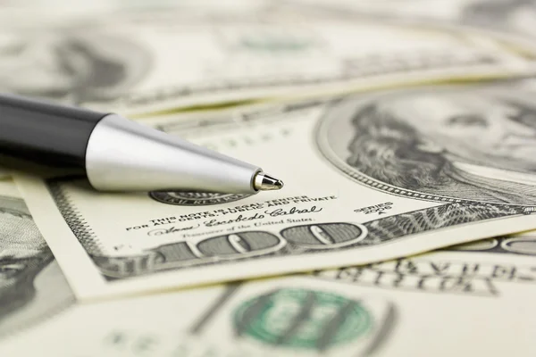 Pen close-up on the dollars money background — Stock Photo, Image