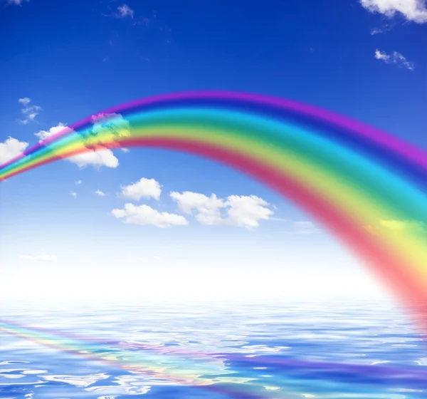 Blue sky background with rainbow and reflection in water — Stock Photo, Image
