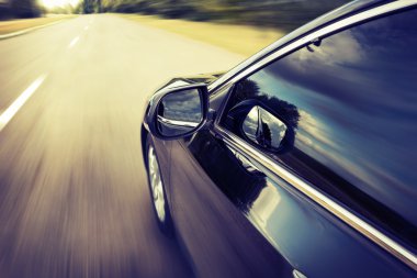 Blurred road and car, speed motion background clipart