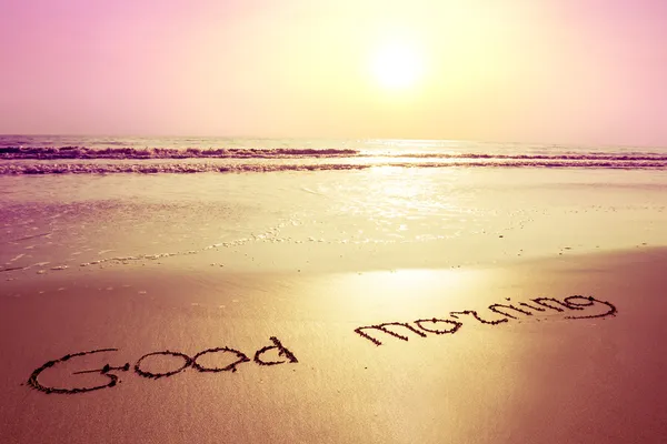 Sunrise,beach and sign on sand good morning — Stock Photo, Image