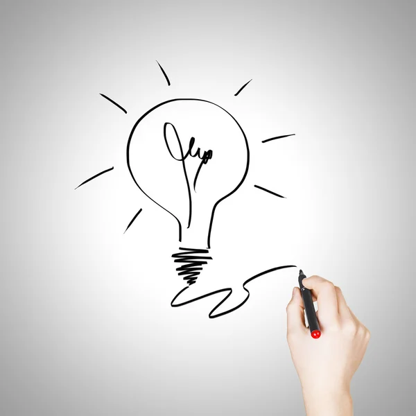 Female hand drawing light bulb — Stock Photo, Image