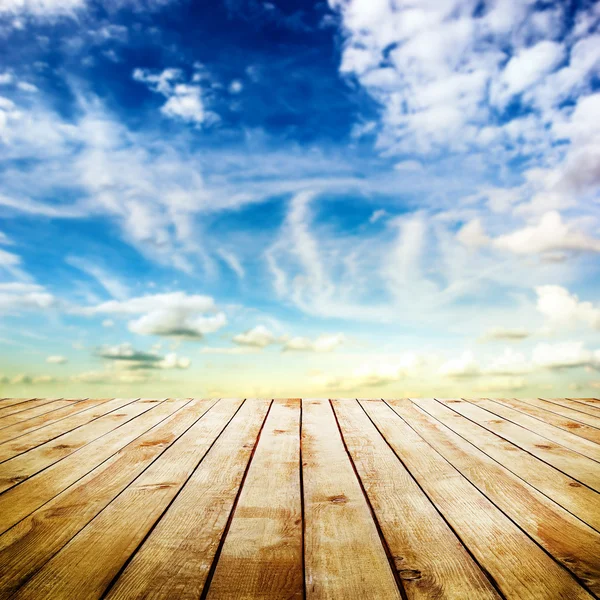 Blue sky with clouds and wood planks floor — Stock Photo, Image