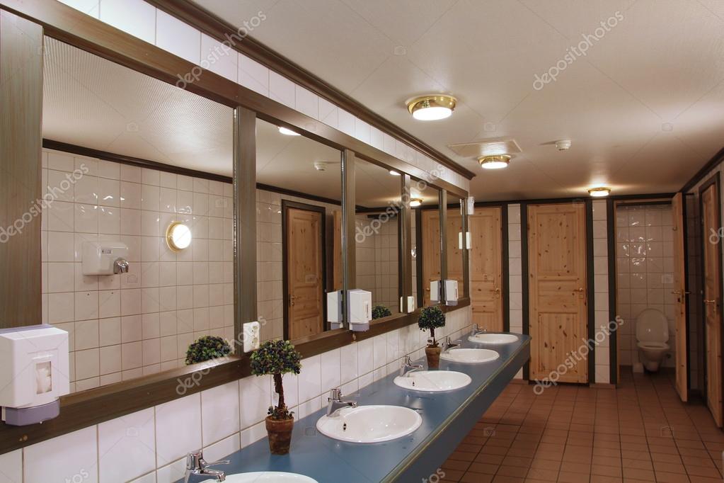 Interior of a clean and tidy public bathroom Stock Photo by ©tupungato