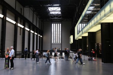 LONDON, İngiltere - 8 Temmuz 2016: İnsanlar Londra 'daki Tate Modern Galerisi' nin yeniden tasarlanmış endüstriyel iç mekanını ziyaret ediyor. Galeri, Londra 'nın Southwark ilçesinin Bankside bölgesinde yer almaktadır..