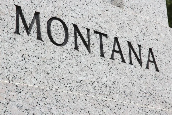 Montana State Name Engraved Grey Granite Stone — стоковое фото