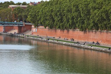 TOULOUSE, FRANCE - 28 Eylül 2021: İnsanlar Toulouse şehir merkezindeki River Garonne barajını ziyaret ediyor. Toulouse Fransa 'daki en büyük dördüncü komün..