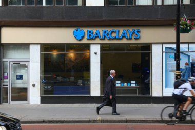LONDON, İngiltere - 7 Temmuz 2016: Londra 'daki Barclays Bank şubesinin önünden geçen kişi. Barclays büyük bir İngiliz finans grubu..