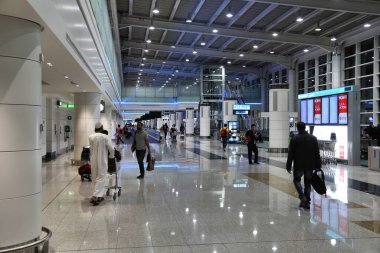 DUBAI, UAE - NOVEMBER 23, 2017: Passengers visit Dubai International Airport, United Arab Emirates. It is one of busiest airports in the world.