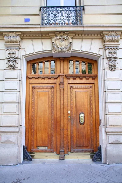 Wooden door in Paris city, France. Typical apartment building.