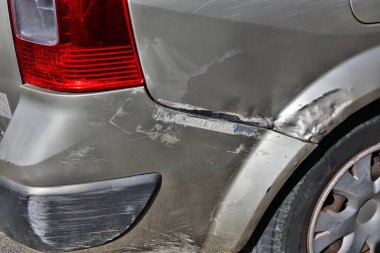 Generic car with scratched paint and dented parts on the side. Minor accident result - fender bender.