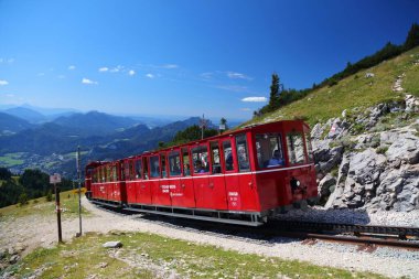 SCHAFBERG, AUSTRIA - AUGUST 3, 2022: People ride the Schafbergbahn to the top of mount Schafberg in Salzkammergut region of Austria. It is a metre gauge cog railway.
