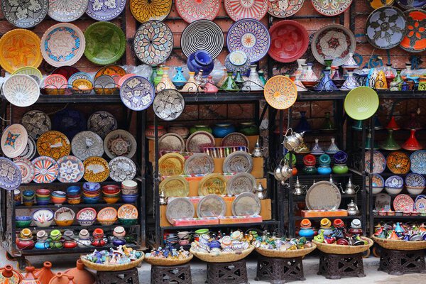 MARRAKECH, MOROCCO - FEBRUARY 20, 2022: Traditional ceramic products in a souk in medina (Old Town) of Marrakech city, Morocco. The historic medina quarter is a UNESCO World Heritage Site.