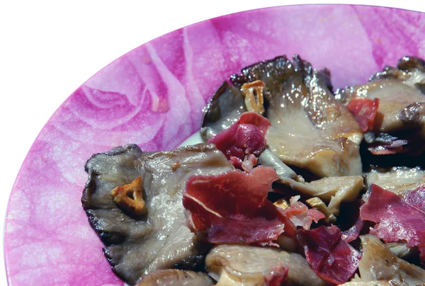 Champignons met ham Stockfoto