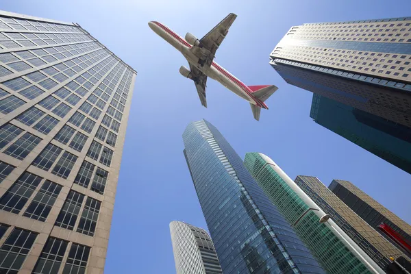 Mira a los aviones está volando modernos edificios de oficinas urbanas —  Fotos de Stock