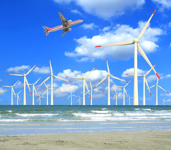 Aircraft is flying in eco power of wind turbines — Stock Photo, Image