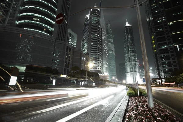 The highway car light trails of modern urban buildings — Stock Photo, Image